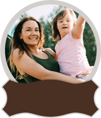 Smiling woman holding happy child outdoors.