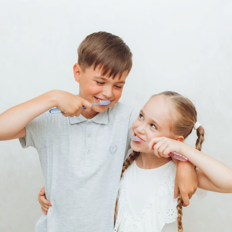 Kids smiling while practicing good oral health & nutrition.