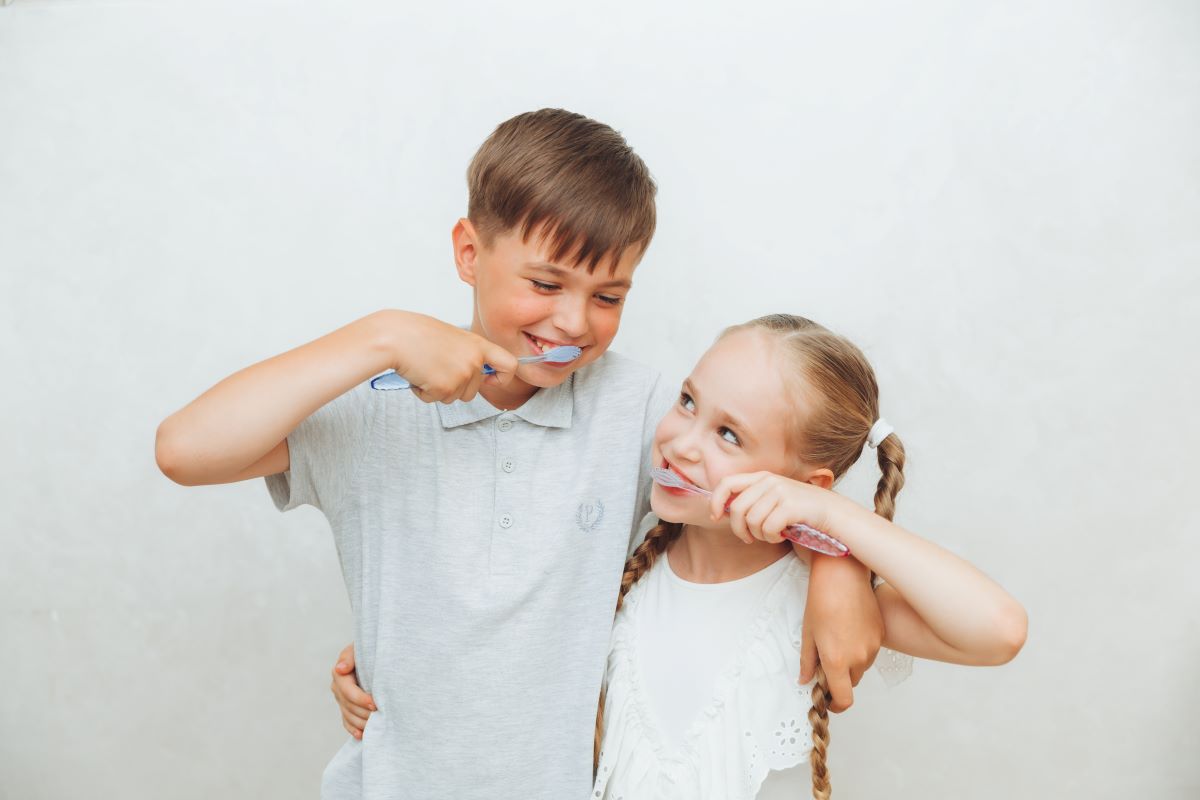 Kids smiling while practicing good oral health & nutrition.