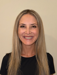 Person smiling against a neutral background